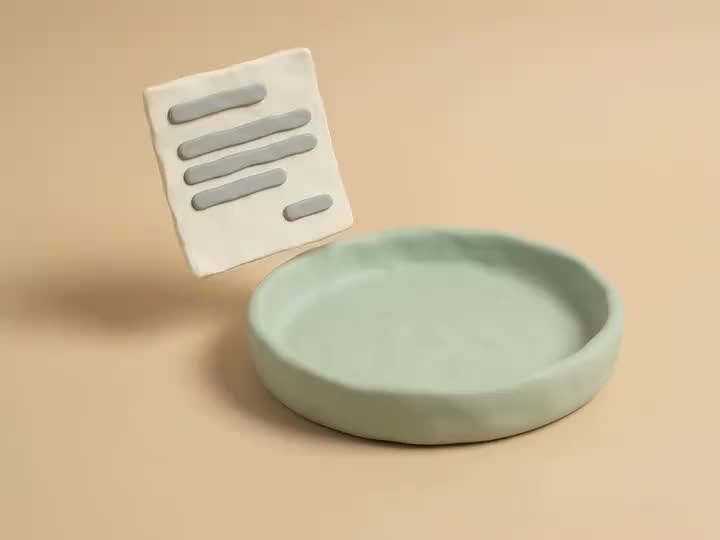 Clay model of a bank statement sliding into a tray, with a checkmark